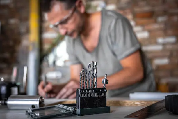 Photo of Close-up set of wood drills on a blurred background.