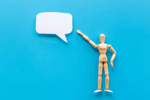 istock Wooden man figure with speech bubble banner 1332104654