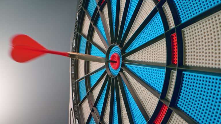 SLO MO LD A dart landing in the inner bullseye on the dartboard