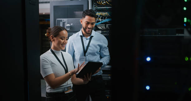 istock Shot of two colleagues working together in a server room 1332104903