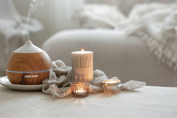 istock Cozy home composition with air humidifier and candles on blurred background. 1332105449