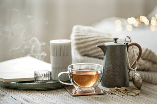 istock Cozy composition with a cup of tea and a teapot on a blurred background. 1332106291