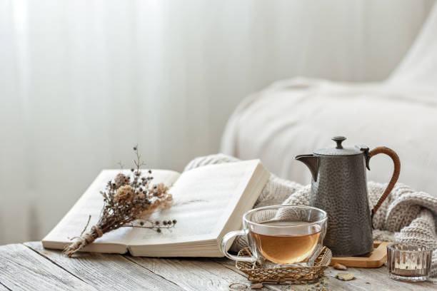 istock Home still life with a cup of tea and a book copy space. 1332106299