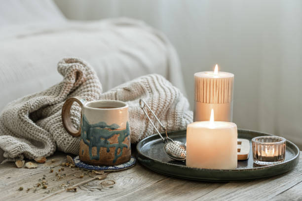 istock Home still life with a cup of tea and burning candles. 1332106301