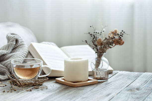 istock Home still life with a cup of tea, a candle and a book. 1332106302