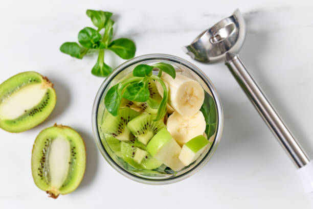 process of making healthy breakfast smoothie - blender apple banana color image imagens e fotografias de stock