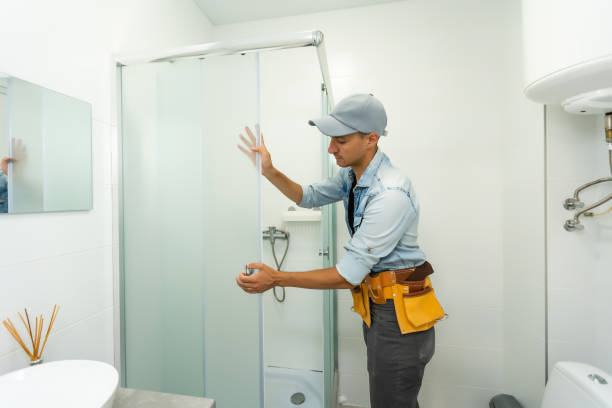 istock Plumber installing a shower cabin in bathroom 1332110022