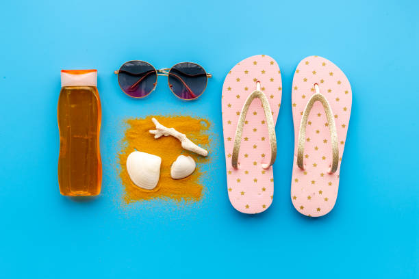 istock Tropical summer vacation background. Flip flops with towel and sunglasses 1332111218