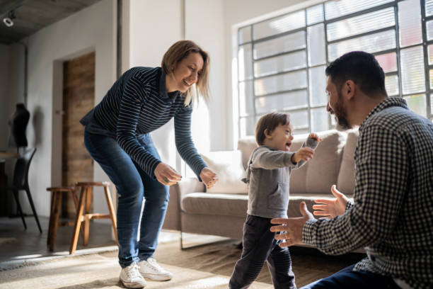 istock Parents helping son with special needs taking his firt steps at home 1332111710