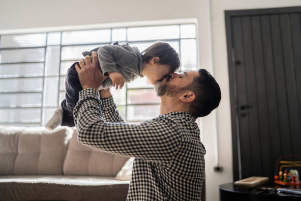 istock Happy father playing with son with special needs at home 1332111739