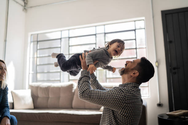 istock Happy father playing with son with special needs at home 1332111809