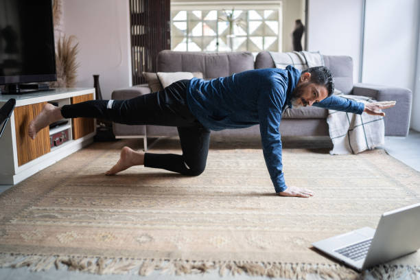 istock Mature man doing online exercise class at home 1332112222