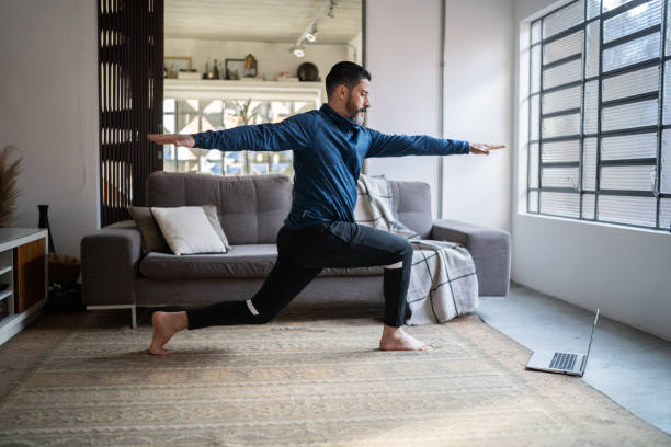 istock Mature man doing online exercise class at home 1332112291