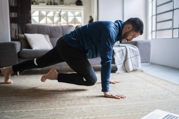 istock Mature man exercising at home 1332112294