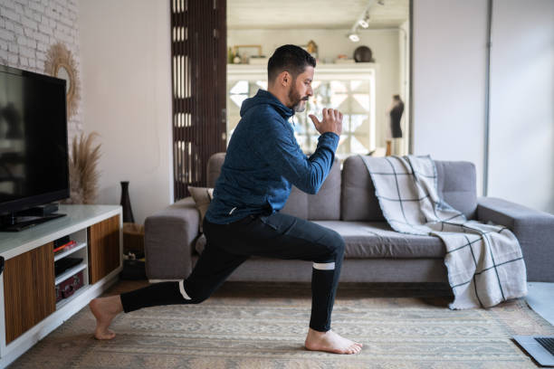 istock Mature man exercising at home 1332112321
