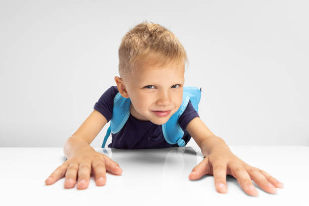 istock Close-up Caucasian preschool boy isolated on white studio background. Copyspace for ad. Childhood, education, emotion concept 1332113258