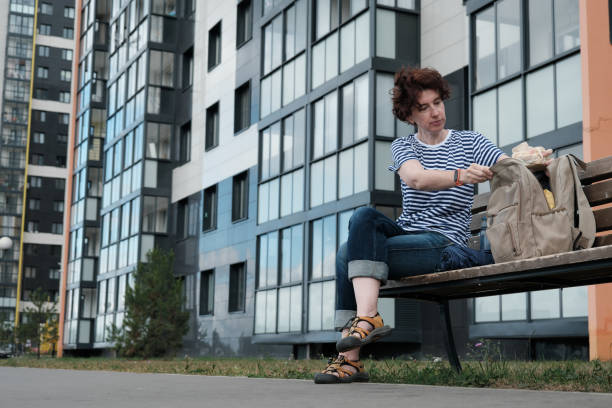 istock Woman is taking a break on bench in the city 1332113828