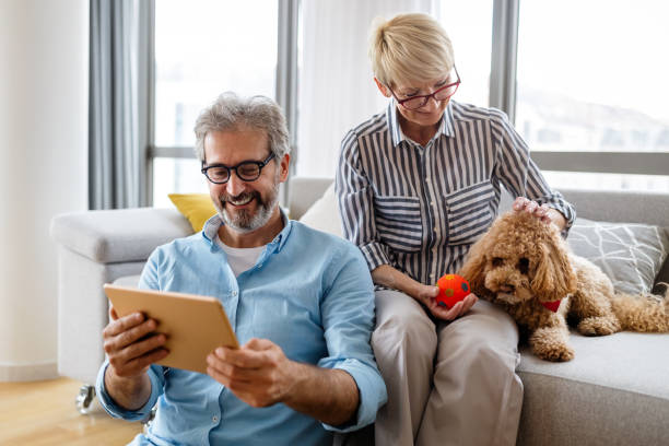 istock Beautiful happy mature couple is using a digital tablet, talking and smiling at home 1332115566