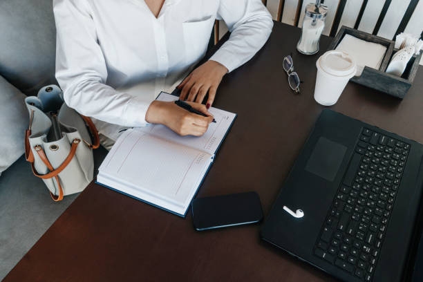 istock Woman hand writing in notebook, top view 1332115733