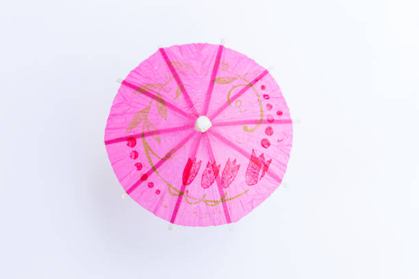 istock Design pink paper umbrella isolate on white background 1332118639