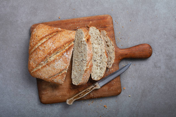 istock Fresh bread slice and cutting knife on table 1332119142