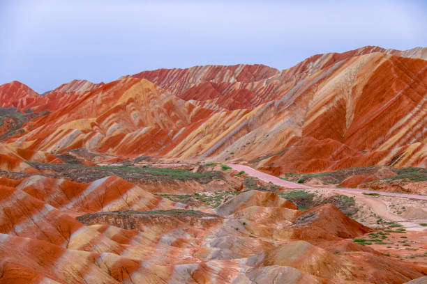 Zhangye Danxia National Geopark Amazing scenery of Rainbow mountain and blue sky background in sunset. Zhangye Danxia National Geopark, Gansu, China. Colorful landscape, rainbow hills, unusual colored rocks, sandstone erosion danxia landform stock pictures, royalty-free photos & images