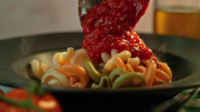 SLO MO Tomato sauce being added onto pasta