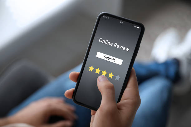 istock Man using smartphone to give feedback indoors, closeup. Customer review 1332121506