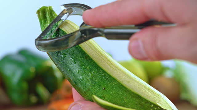 SLO MO LD A zucchini being peeled