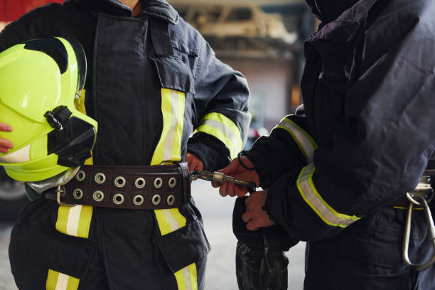 istock Male and female firefighters in protective uniform standing together 1332125274