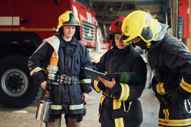 istock With notepad. Group of firefighters in protective uniform that is on station 1332126811