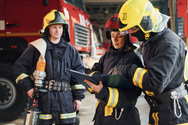 istock With notepad. Group of firefighters in protective uniform that is on station 1332126812