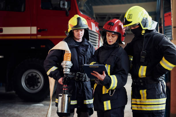 istock With notepad. Group of firefighters in protective uniform that is on station 1332126948