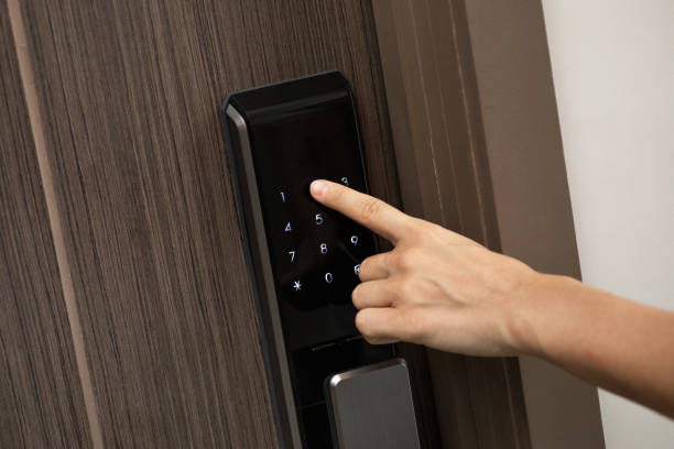 istock Hand and digital smart code lock into the modern apartment 1332127045