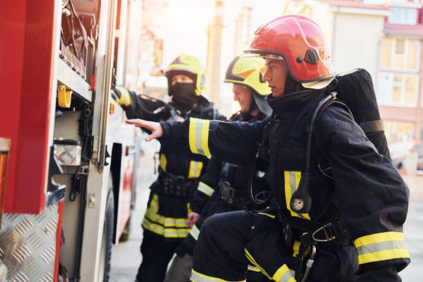 istock Group of firefighters in protective uniform that outdoors near truck 1332127168