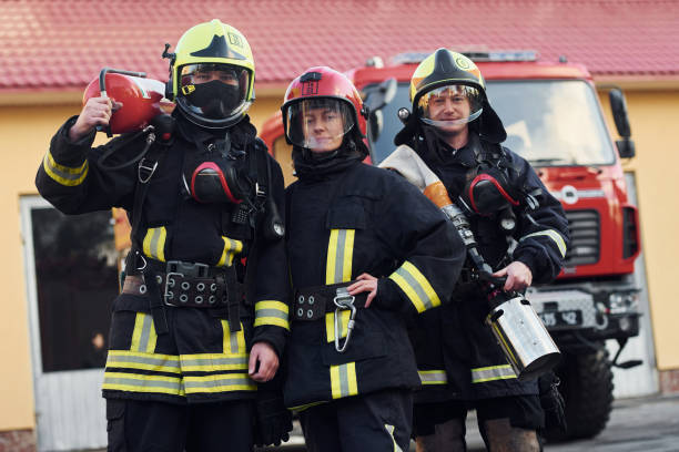 istock Group of firefighters in protective uniform that outdoors near truck 1332127242