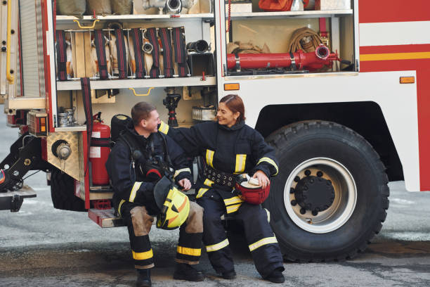 istock Male and female firefighters in protective uniform is outdoors together 1332127253