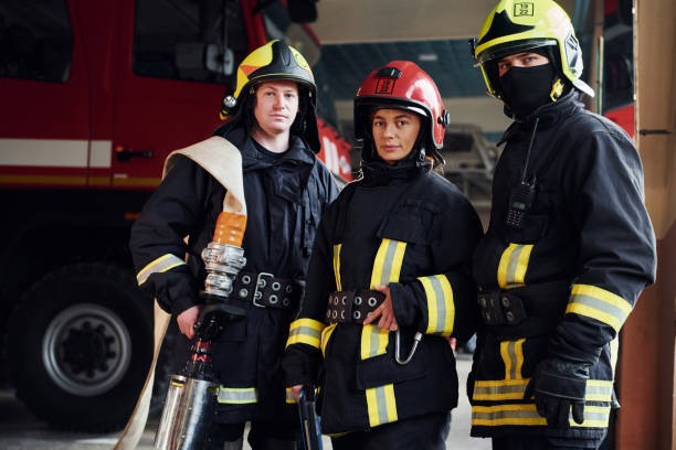 istock Posing for a camera. Group of firefighters in protective uniform that is on station 1332127356