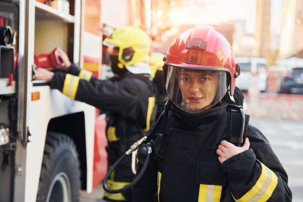 istock Group of firefighters in protective uniform that outdoors near truck 1332127363