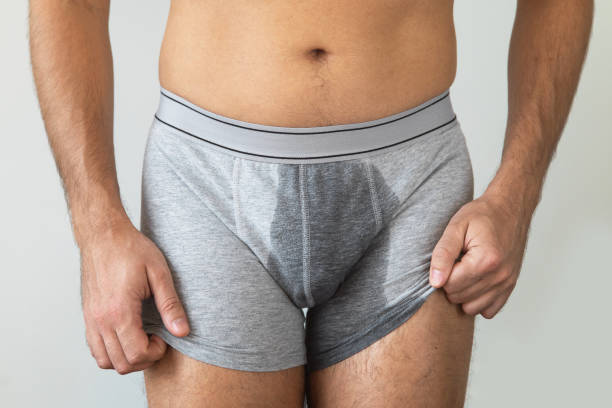 Man with wet briefs because of urinary incontinence Man with wet briefs because of urinary incontinence on gray background koteka stock pictures, royalty-free photos & images