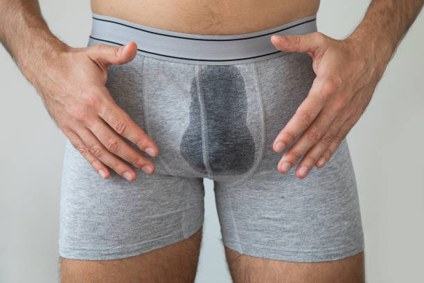 Man with wet briefs because of urinary incontinence Man with wet briefs because of urinary incontinence on gray background koteka stock pictures, royalty-free photos & images
