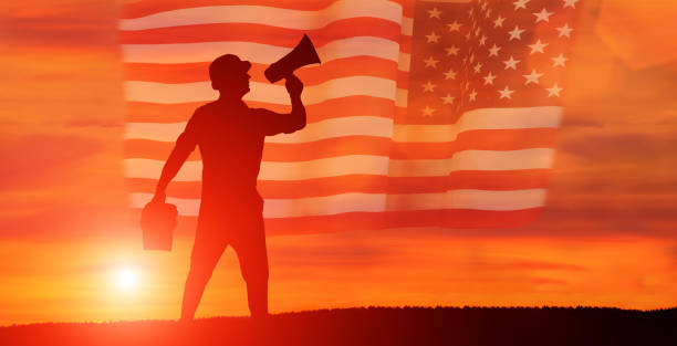 istock Worker on the USA flag background . Labor day holiday concept. 1332134350