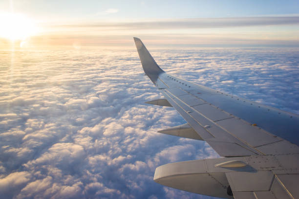 istock Wing passenger planes, blue sunny sky and clouds. Travel concept. 1332135233