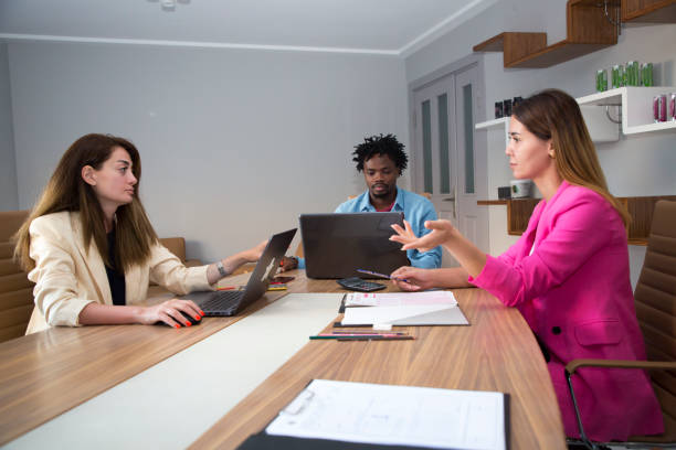 istock Young business colleagues in board room at office 1332135429