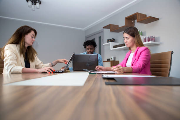 istock Young business colleagues in board room at office 1332135447