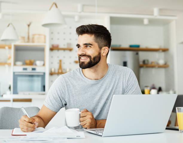 istock laptop man computer home technology young  lifestyle business internet study indoor male reading 1332136892