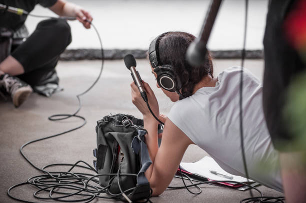 Behind the scene. Sound boom operator hold microphone fisher outdoor Behind the scene. Sound boom operator resting on the set and hold microphone fisher outdoor sound technician stock pictures, royalty-free photos & images