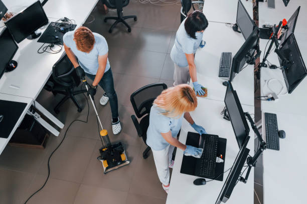 istock Top view. Group of workers clean modern office together at daytime 1332138421
