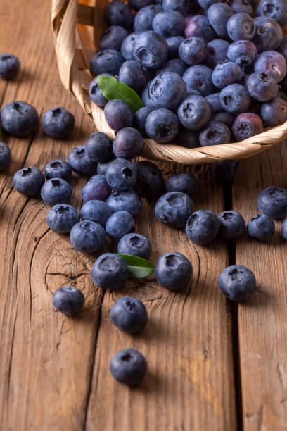istock Blueberries in basket on wooden table 1332138608
