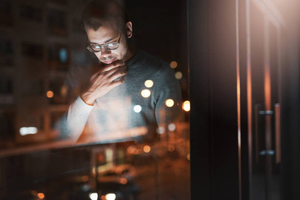 istock Shot of a young man using a digital tablet reflected in an office window 1332139216